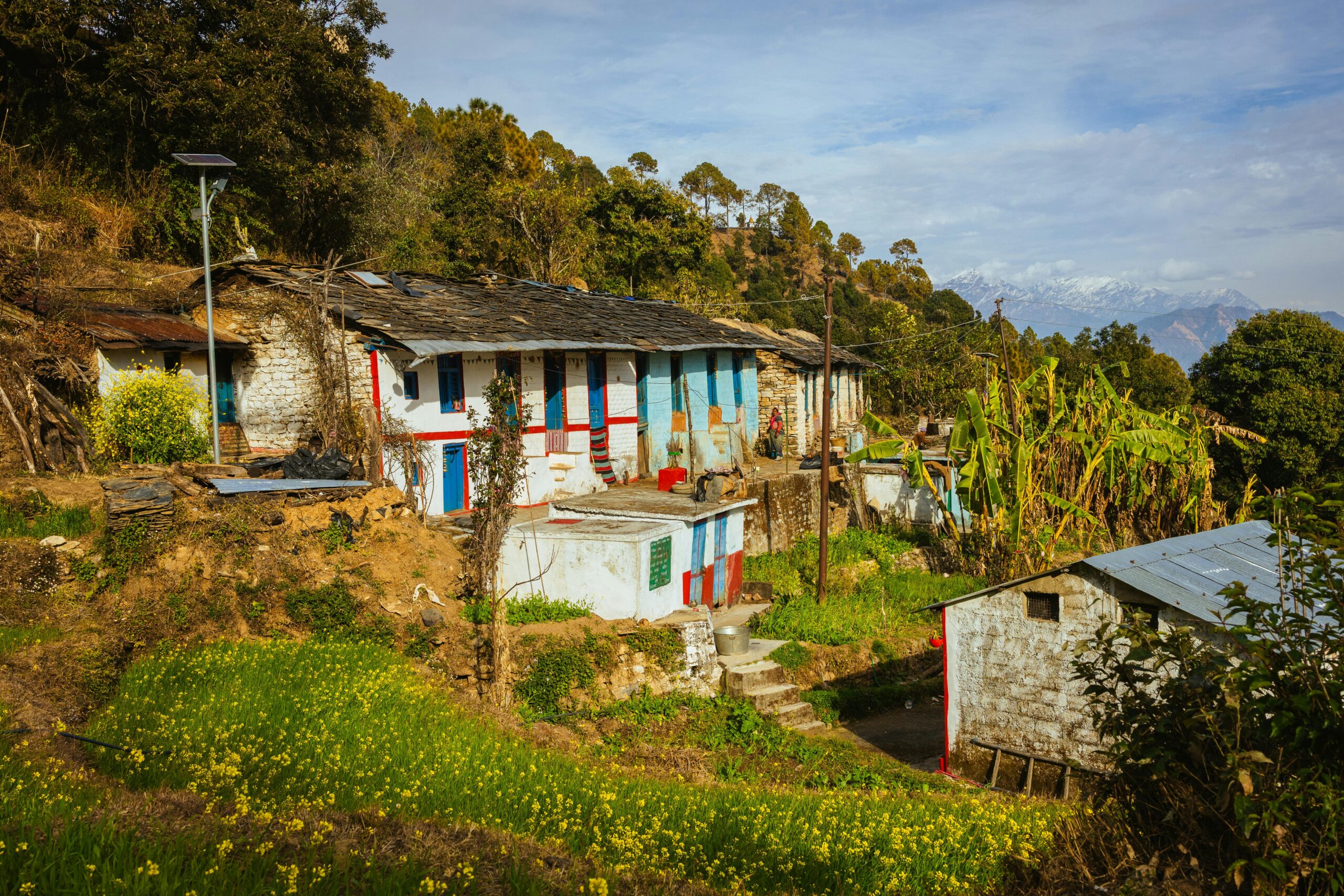Picturesque village in Uttarakhand nestled in the Himalayas with traditional houses and lush greenery.